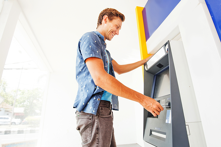 Man inserting card into ATM