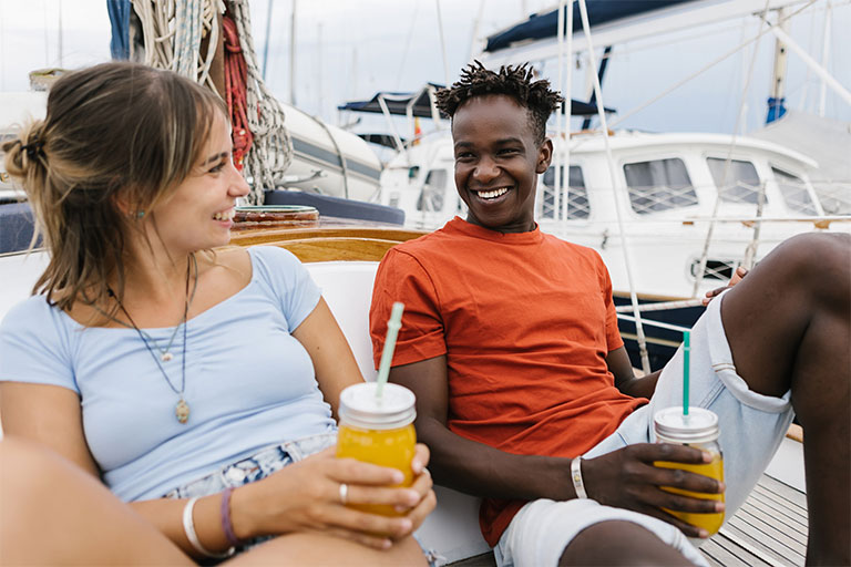 Multiracial friends enjoying themselves on a boat